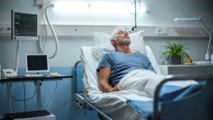 A senior patient lying in a hospital bed