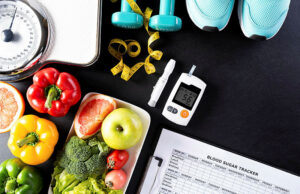 Healthy food, weight scale, sports shoes, dumbbells, tape measure and blood sugar testing kit